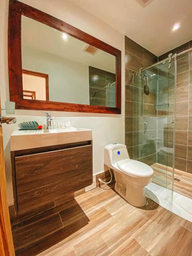a bathroom with a sink and a shower and a toilet at In Di House of Reggae Boutique in San Andrés