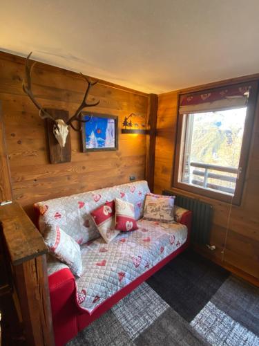 a living room with a couch and a window at Baita delle marmotte CIR n 0012 in Breuil-Cervinia