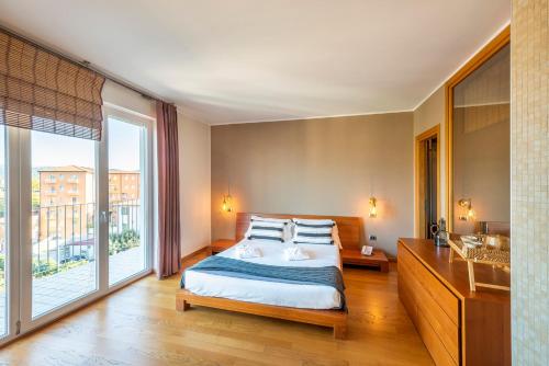 a bedroom with a bed and a large window at Hotel San Marco Fitness Pool & Spa in Verona