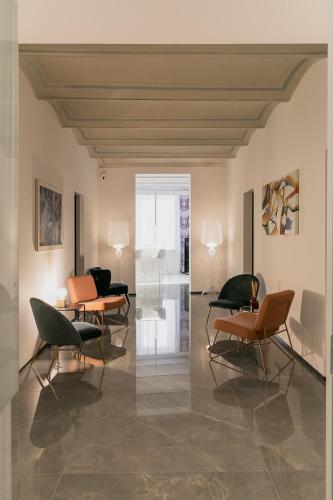a room with chairs and tables in a building at WeLive in Carpi