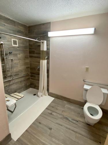 a bathroom with a toilet and a shower at Motel 6 Marianna, FL in Marianna
