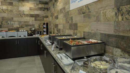 a kitchen with a bunch of food on a counter at Holiday Inn Express and Suites Celaya by IHG in Celaya