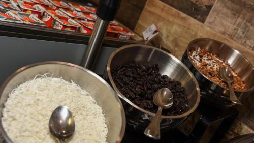 a counter with three bowls of rice and spoons at Holiday Inn Express and Suites Celaya by IHG in Celaya