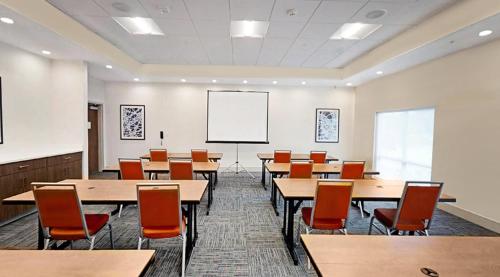 a classroom with tables and chairs and a whiteboard at Holiday Inn Express & Suites - Chalmette - New Orleans S by IHG in Chalmette