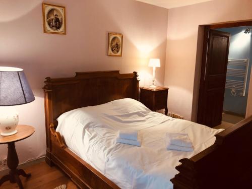 En eller flere senge i et værelse på Domaine Du Bas De Chene
