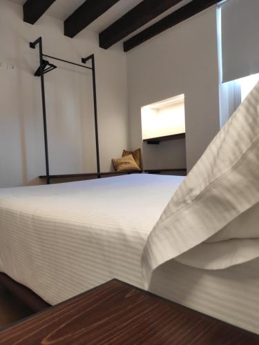 a bedroom with a large white bed in a room at Borgo di Ponte Holiday Apartments & Rooms in Cividale del Friuli