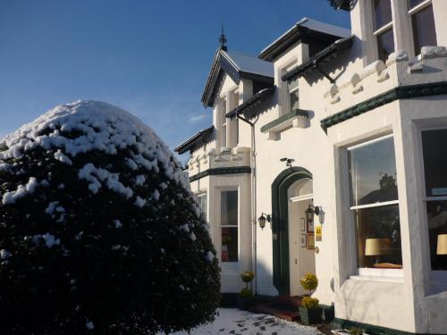 a large snow covered ball in front of a house at Moyness House in Inverness