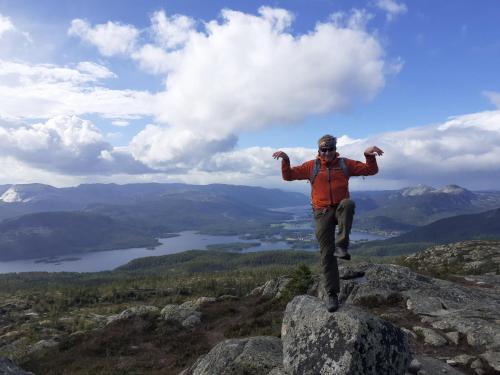 a man standing on a rock on a mountain at Norbel Hytte Norway in Vradal