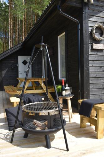 a black cabin with a swing in front of it at Norbel Hytte Norway in Vradal