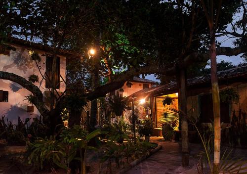 a house with trees and plants at night at Pousada Zen Caraiva in Caraíva