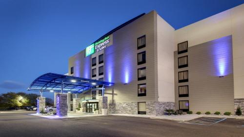 a hotel building with a sign on the front of it at Holiday Inn Express & Suites Jackson Downtown - Coliseum by IHG in Jackson
