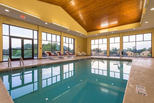 a swimming pool in a building with windows and a large pool at Holiday Inn Express & Suites Lexington North West-The Vineyard, an IHG Hotel in Lexington