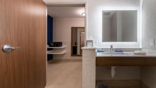a bathroom with a sink and a mirror at Holiday Inn Express & Suites - Marion by IHG in Marion