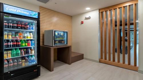 a soda machine in a store with a television at Holiday Inn Express & Suites - Marion by IHG in Marion