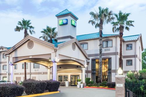 a hotel with a clock tower on top of it at Holiday Inn Express Hotel and Suites Lake Charles by IHG in Lake Charles