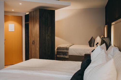 Postel nebo postele na pokoji v ubytování Hotel Dakota