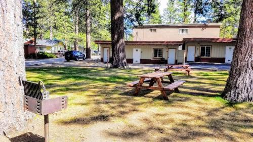 a picnic table and a bench in a park at The Washoe Lodge in South Lake Tahoe