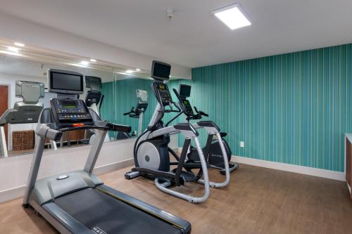 a gym with two exercise bikes and a treadmill at Holiday Inn Express & Suites Milton East I-10 by IHG in Milton