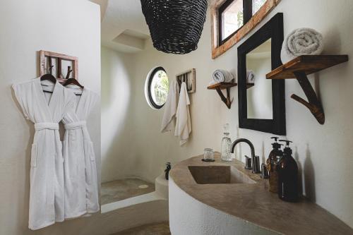 a bathroom with a sink and a mirror at NEST Tulum in Tulum