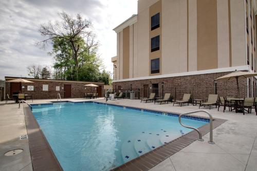 a large swimming pool in front of a building at Holiday Inn Express Natchez South West, an IHG Hotel in Natchez