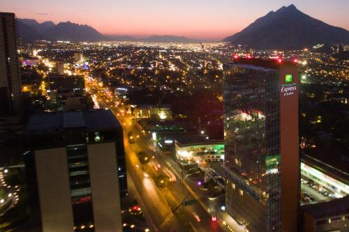 a view of a city at night with buildings at Holiday Inn Express & Suites Monterrey Valle by IHG in Monterrey