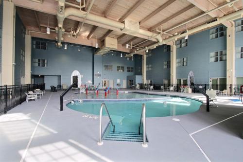a large pool in a large building with an indoor at Holiday Inn Express Hotel & Suites Milwaukee Airport by IHG in Milwaukee