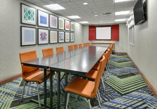 a conference room with a long table and chairs at Holiday Inn Express & Suites Mitchell by IHG in Mitchell