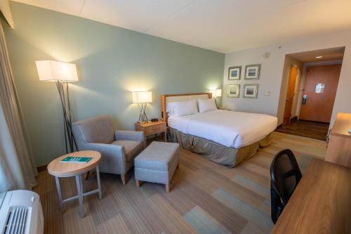 a hotel room with a bed and a chair at Holiday Inn Manahawkin/Long Beach Island by IHG in Manahawkin
