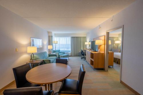 a hotel room with a table and a living room at Holiday Inn Manahawkin/Long Beach Island by IHG in Manahawkin