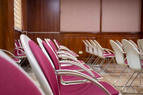 a row of chairs in a room with purple seats at REGAL HOTEL in Machala