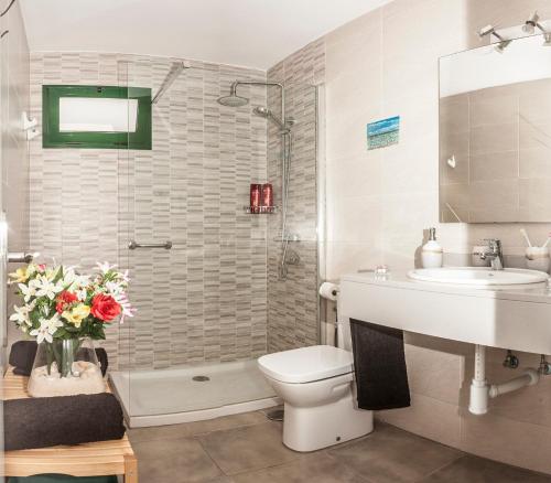 a bathroom with a toilet and a sink and a shower at Apartamentos los volcanes in Puerto del Carmen