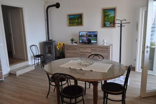 a dining room with a table and chairs and a tv at Holiday home near Monte Baldo in Tremosine Sul Garda in Tremosine Sul Garda
