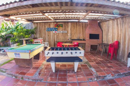 a patio with two ping pong tables on a brick patio at Hotel Mar e Sol - Capão da Canoa in Capão da Canoa