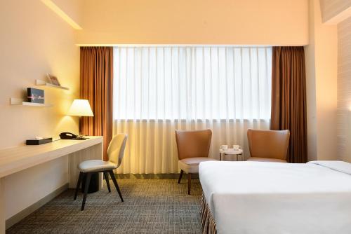 Postel nebo postele na pokoji v ubytování Caesar Park Hotel Taipei