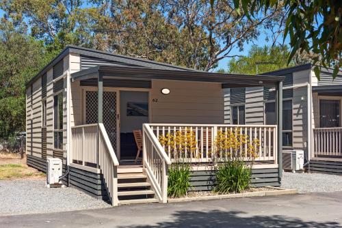 a tiny house with stairs and a porch at Discovery Parks - Barossa Valley in Tanunda