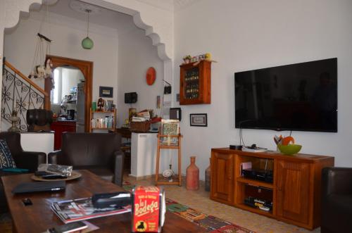a living room with a flat screen tv on a wall at Tanger Chez Habitant in Tangier