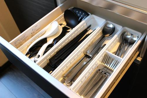 a drawer with knives and utensils in it at Holiday home Furinkazan 風林火山 in Fujikawaguchiko
