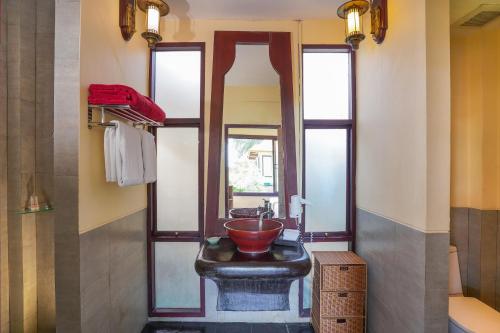 a bathroom with a black sink and a mirror at The Briza Beach Resort, Samui - SHA Plus in Chaweng