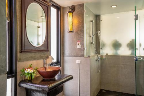 a bathroom with a bowl sink and a shower at The Briza Beach Resort, Samui - SHA Plus in Chaweng