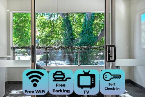 a window with signs in a room with a tree at Woody lifestyle one bedroom apartment in Olinda