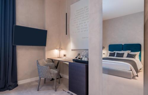 a bedroom with a bed and a desk with a chair at Monograph Freedom Square in Tbilisi City
