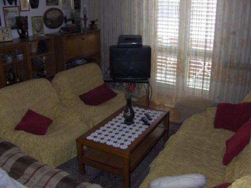 a living room with two couches and a tv at Dubrovnik Sea View Apartment in Dubrovnik