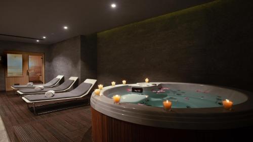 a spa room with a jacuzzi tub with candles at InterContinental Cairo Semiramis by IHG in Cairo