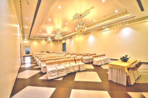 a large banquet hall with tables and chairs and chandeliers at RUDRA VILAS - A Royal Heritage Hotel in Jaipur