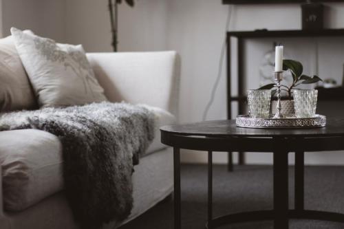 a living room with a couch and a table with candles at Hotell Villa Borgen in Visby