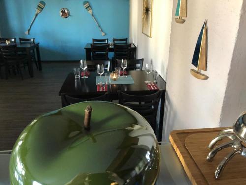 a restaurant with a green bowl on a table at Hotel Berghof by 42 in Koblenz