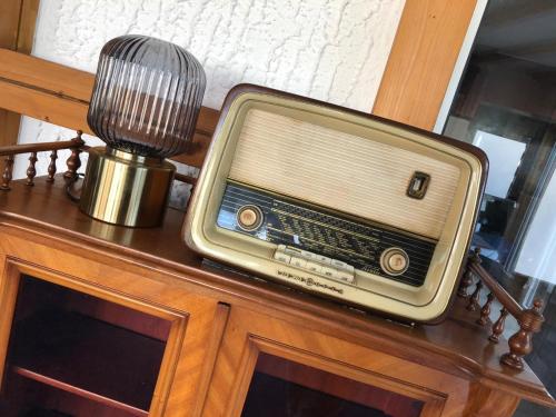 an old radio sitting on top of a table at Hotel Berghof by 42 in Koblenz
