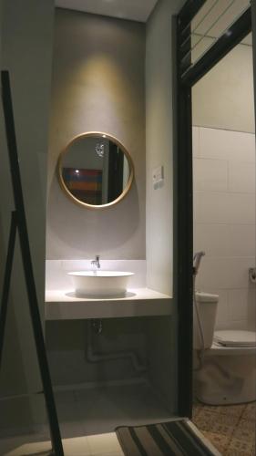 a bathroom with a sink and a mirror at SaBi Guest House - Strategic Family -married couples only- Hostel in Prawirotaman in Yogyakarta
