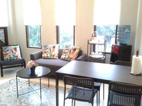 a living room with a couch and a table and chairs at SaBi Guest House - Strategic Family -married couples only- Hostel in Prawirotaman in Yogyakarta