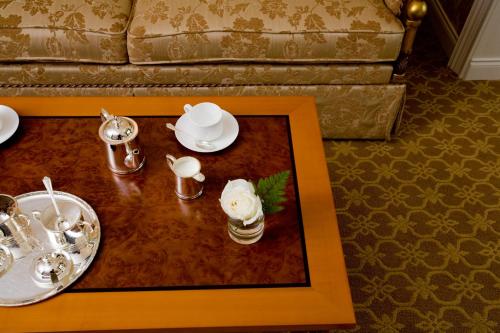 a table with plates and dishes on top of it at Terelj Hotel & Spa in Ulaanbaatar